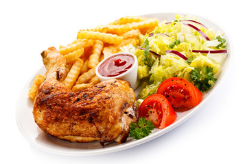 Grilled chicken legs with chips and vegetables 