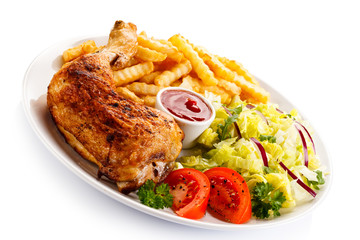 Grilled chicken legs with chips and vegetables 