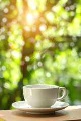 White cup coffee with nature background.