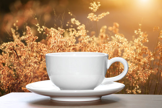 White cup coffee with nature background.