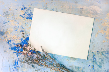 Blank Card And Dried Flowers On The Blue Wooden Background