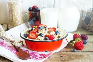 Healthy oatmeal porridge with berries and nuts for breakfast