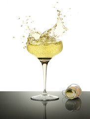 champagne splashing and cork on white background
