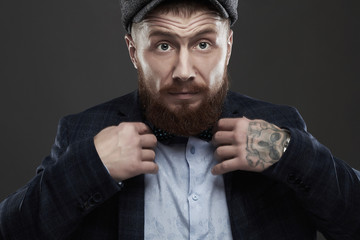 tattoo bearded man in hat.old Hipster boy.handsome Brutal man with red beard