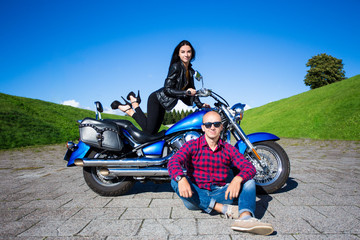 Plakat young handsome man and sexy woman posing with vintage motorbike