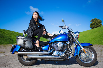 Fototapeta na wymiar young sexy woman posing with vintage motorbike