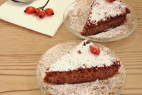 Two Slices Of Chocolate Cake And Rose Hips