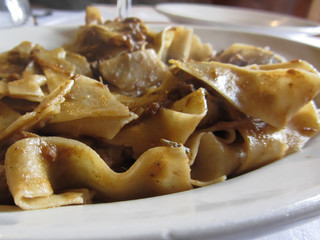Pappardelle with boar ragu. Tuscan typical recipe of italian pasta