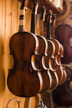 Three unfinished violins in workshop of instrument maker