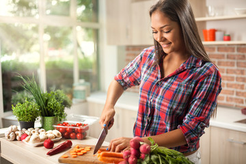 young asian woman  chopping  vegetables for detox in kitchen