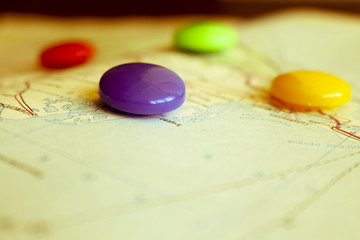 Travel destination points on a map indicated with colorful thumbtacks and shallow depth of field...