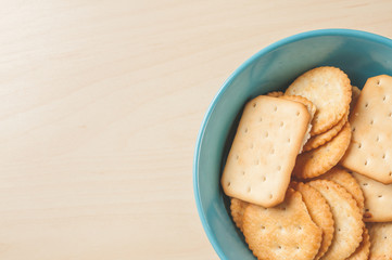 crackers cheese and crackers sugar in color bowl on wood table,