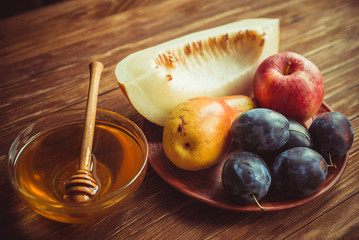 Fruits and honey on the table.