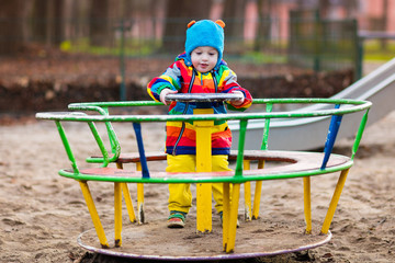 Little boy on playground in autumn