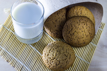 Sweet Christmas cookies with milk on wooden desks