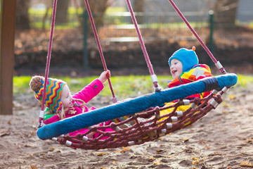 Kids on playground swing