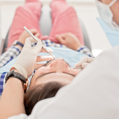 young happy man and woman in a dental examination at dentist