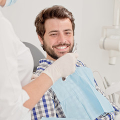 young happy man and woman in a dental examination at dentist