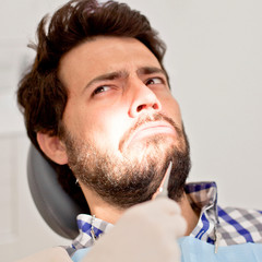 young man and woman in a dental examination at dentist