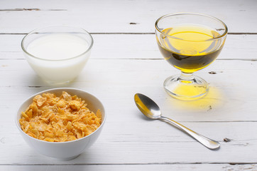 Ingredients for a healthy breakfast: cornflakes, milk and honey.