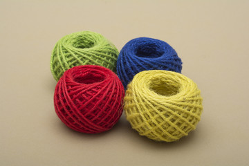 Red, Green, yellow, blue threads on dark background