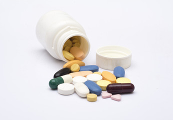 colorful pills of medicine from a plastic drug bottle