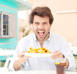 Young man holding a chips