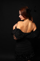 Naklejka premium beautiful mysterious woman posing with hands on black background