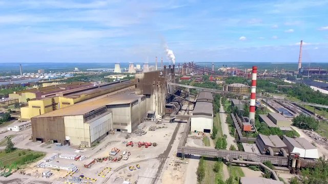 Steel factory with smokestacks at suny day.Metallurgical plant. steelworks, iron works. Heavy industry in Europe.Air pollution from smokestacks, ecology problems. Industrial landscape.View from above.