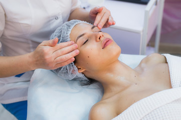 Obraz na płótnie Canvas Smiling brunette enjoying a head massage in the health spa