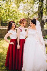 Fototapeta na wymiar Bride with bridesmaids. Friends in the same dress