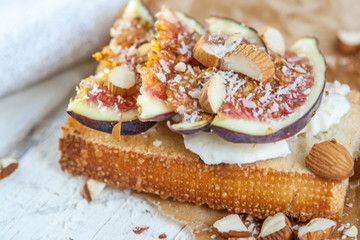 Bruschetta with goat cheese and figs on list of parchment