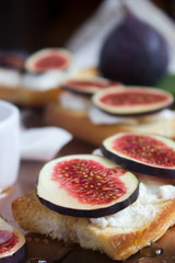 Bruschetta with goat cheese and figs on copper tray