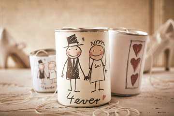 Married forever symbol written on stringed cans