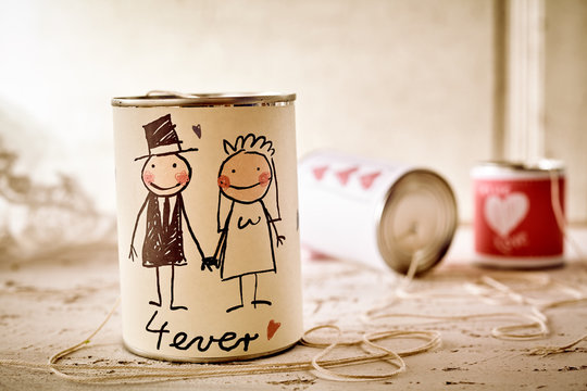 Scribbled newlywed couple on can with string