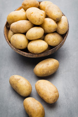 New potato on the bowl, gray background.