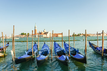 Obraz na płótnie Canvas Gondolas moored by Saint Mark square with San Giorgio di Maggior