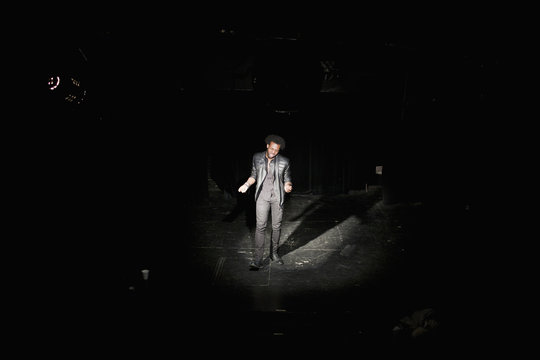 Young male singer performing at a theater