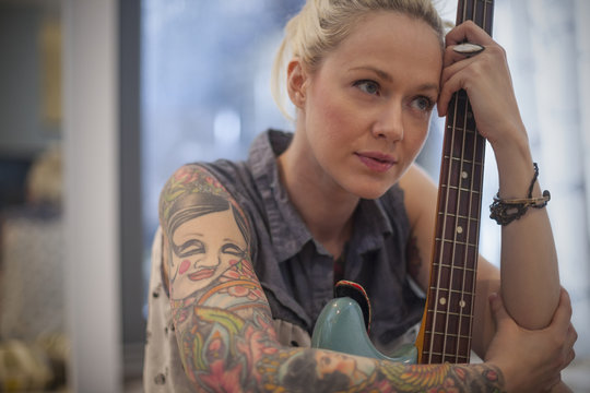 Young woman with electric guitar