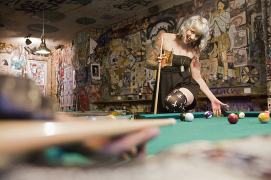 Young woman playing pool