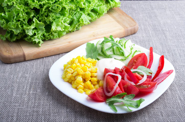 Useful natural salad on a gray tablecloth