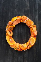 Flat lay series of complete alphabet made from orange fruit and