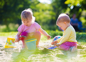 Two children playing in sandbox