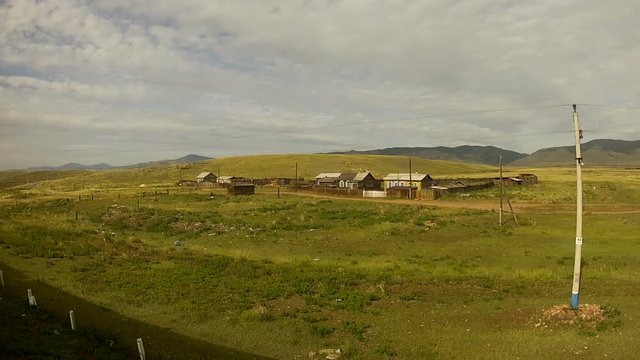 Trans-Siberian Railway train passing by a little village in siberia