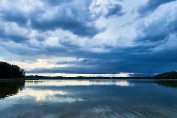 Dramatic Storm Clouds over beautiful Lemiet lake in Mazury district, Poland. Fantastic travel destination.