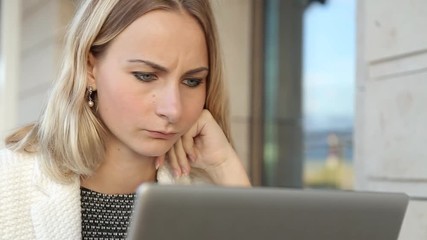 Woman online shopping via laptop in cafe - Powered by Adobe