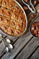 Turkish baklava on the wooden background, top view