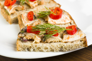 Fototapeta na wymiar sandwiches with herring, red pepper and dill