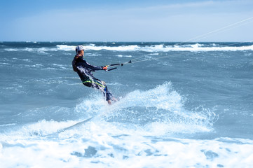 young man kiting in clear blue water