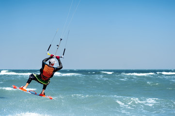 young man kiting in clear blue water